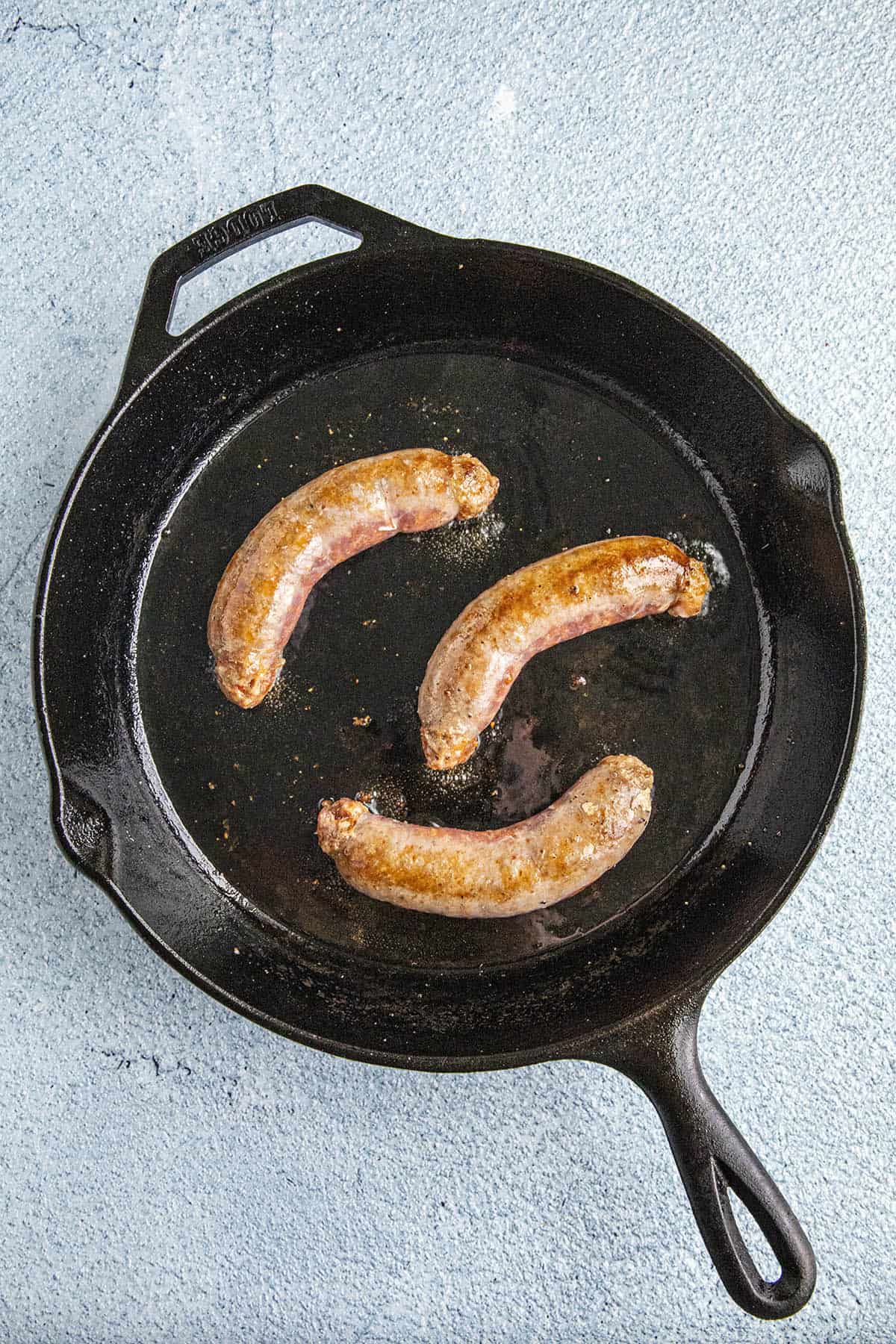 Browning the sausages to make Chicken Scarpariello