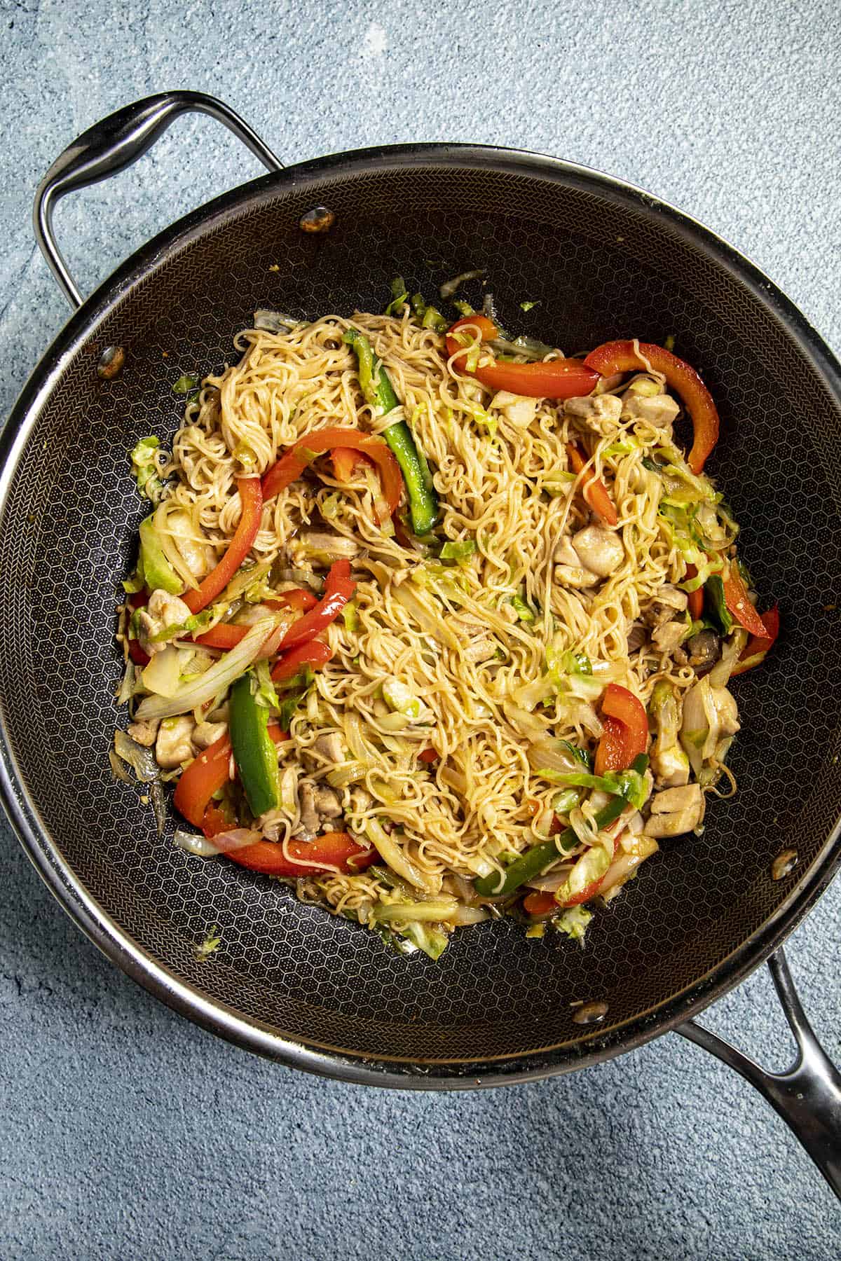 Mixing the noodles into the Chow Mein