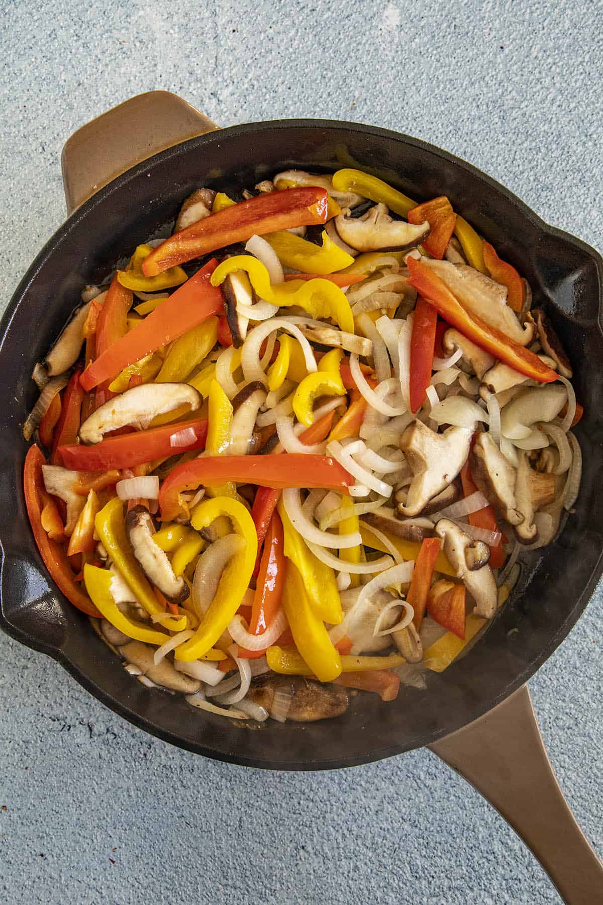 Cooking peppers, onions and mushrooms to make Chicken Cacciatore