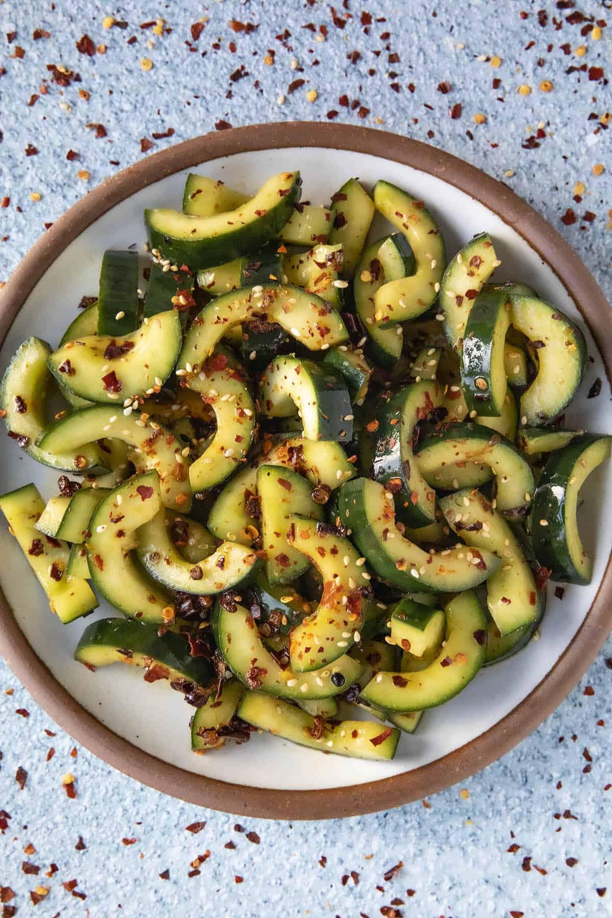 Sichuan Spiced Cucumber Salad on a plate with garnish