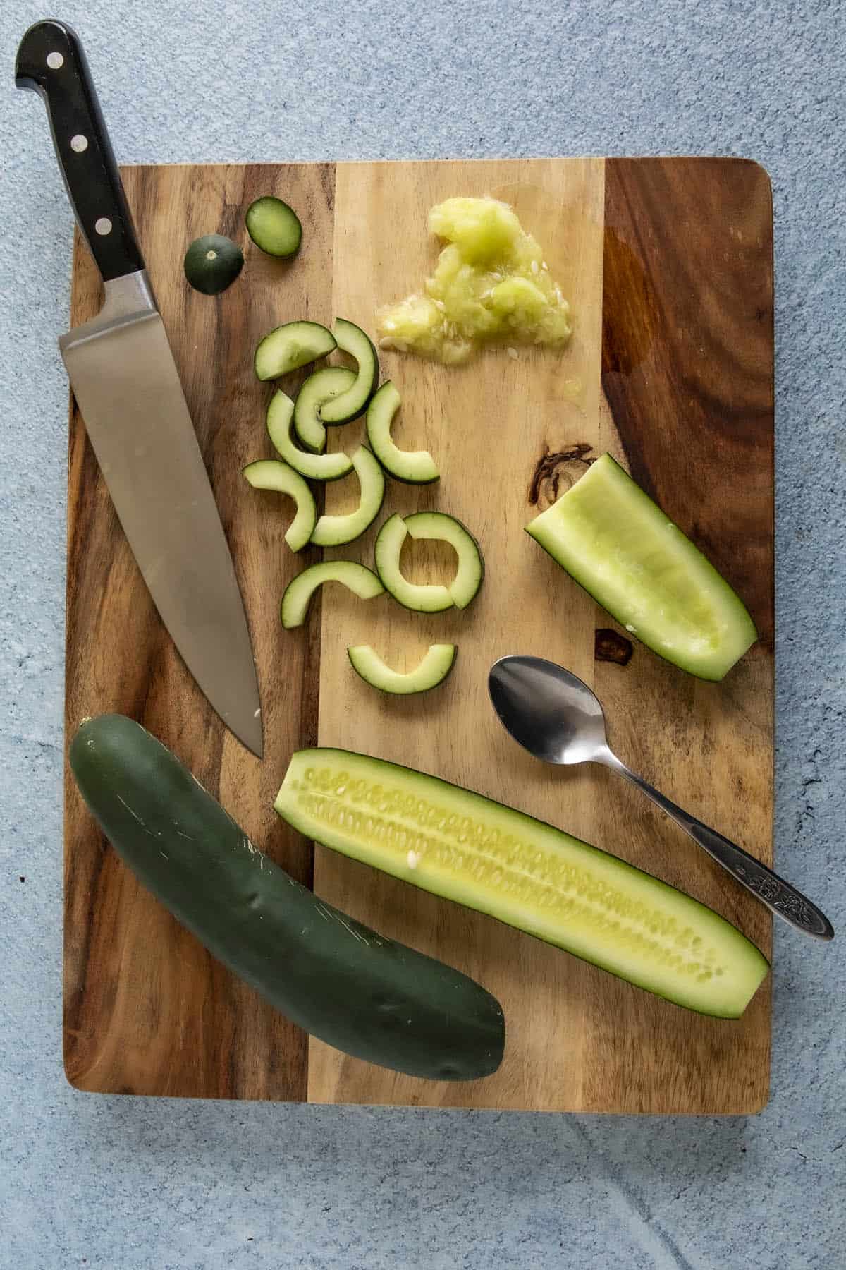 Slicing cucumbers to make Sichuan spiced cucumber salad