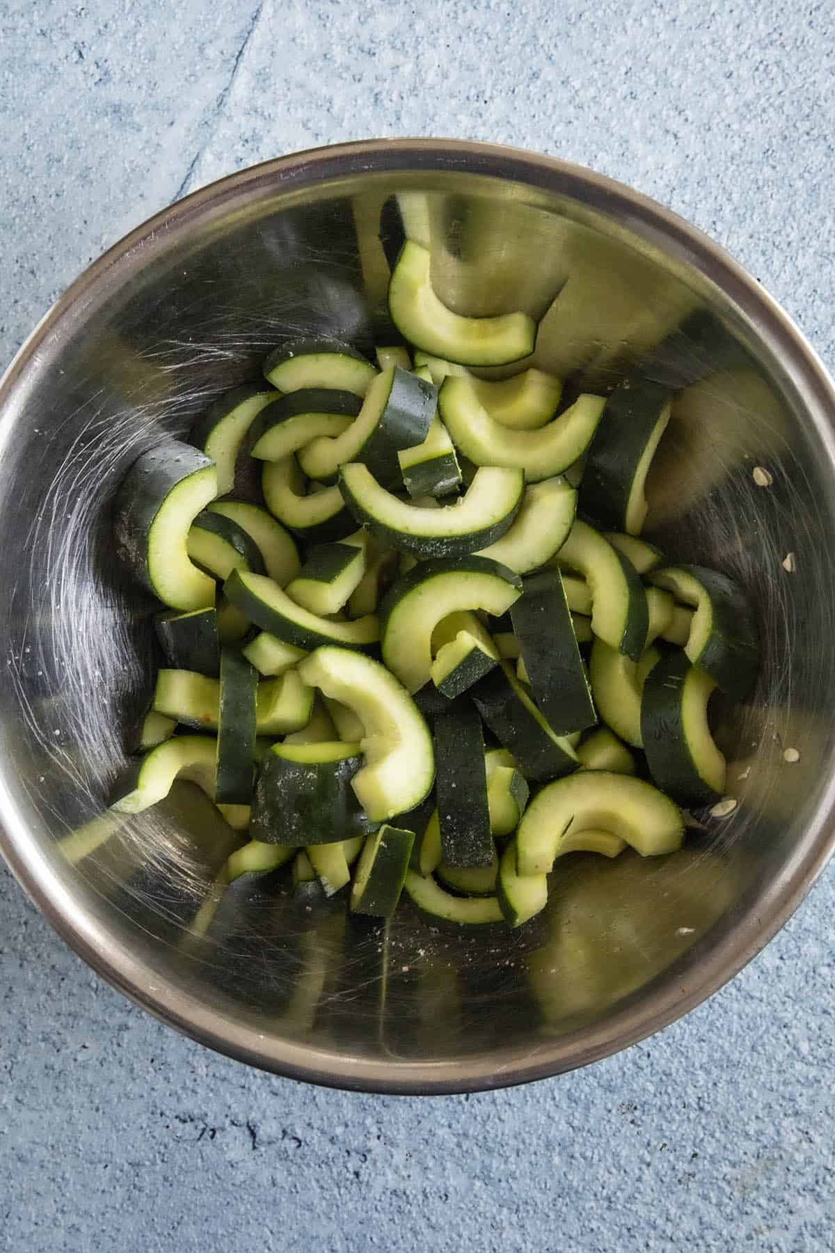 Sliced cucumbers draining in a bowl