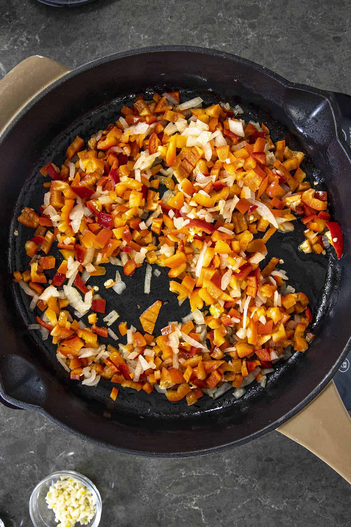 Cooking peppers and onions in a pan to make Menemen