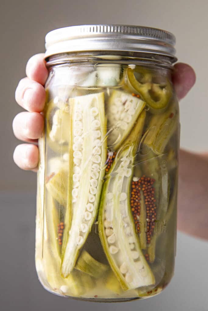 Mike holding a jar of Pickled Okra