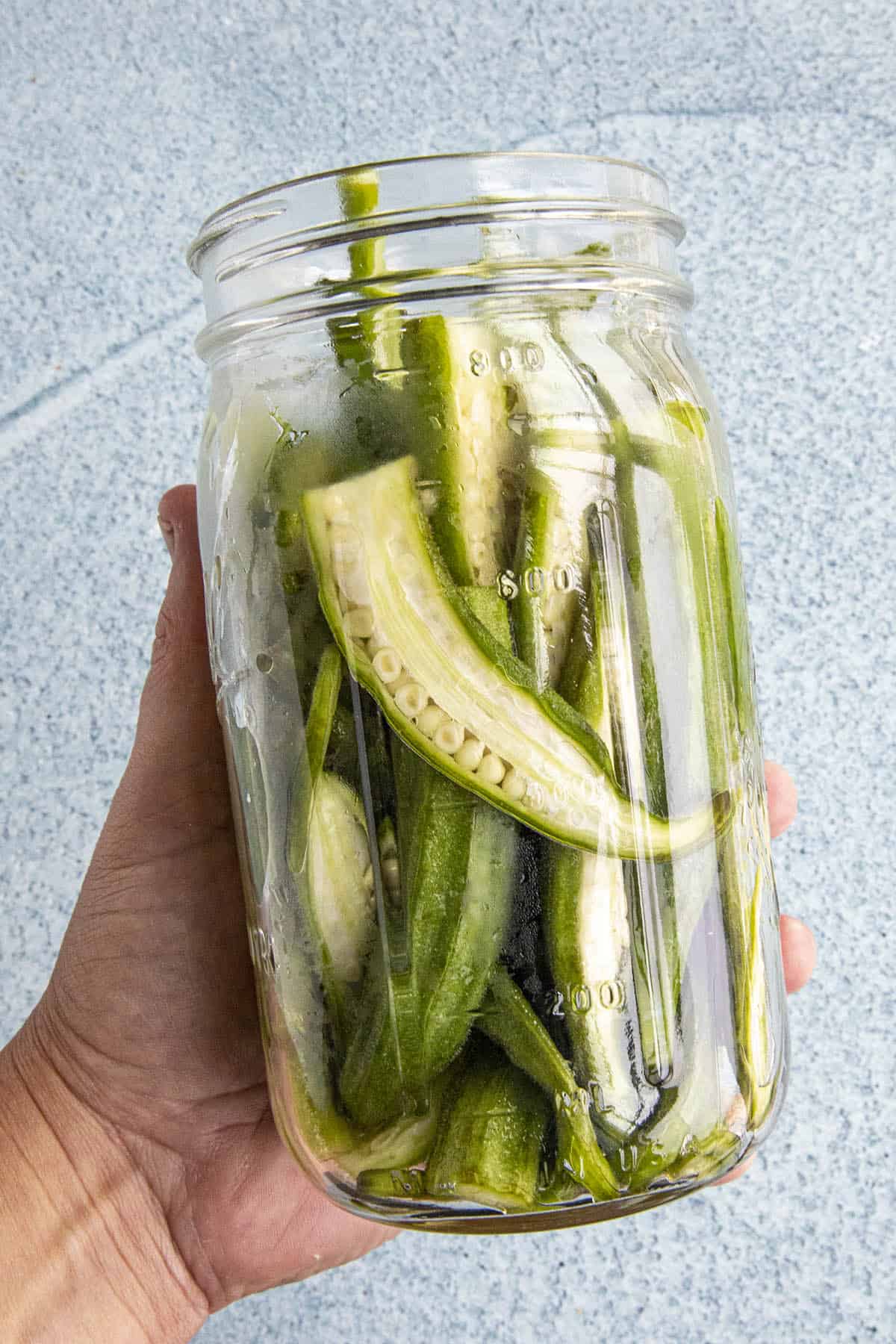 Fresh sliced okra in a pickling jar