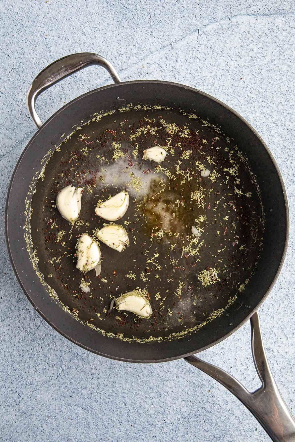 Pickling liquid in a pan for making pickled okra