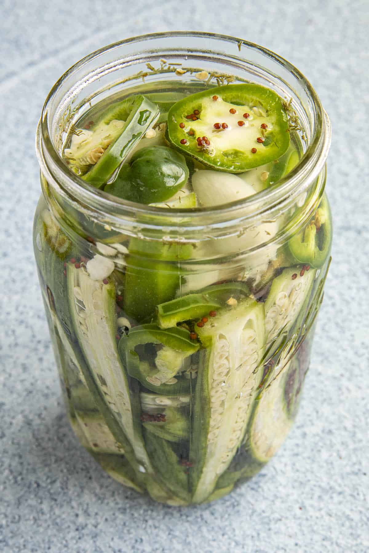 Pickled Okra in a jar with fresh pickling liquid