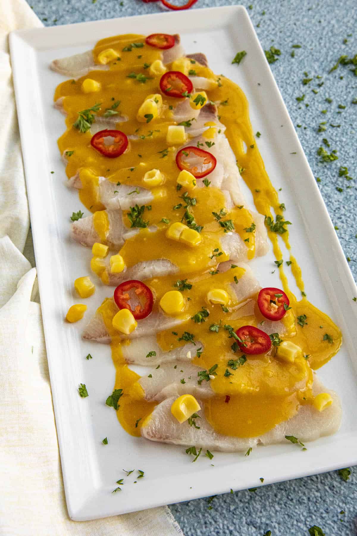 Peruvian Tiradito on a platter with garnish