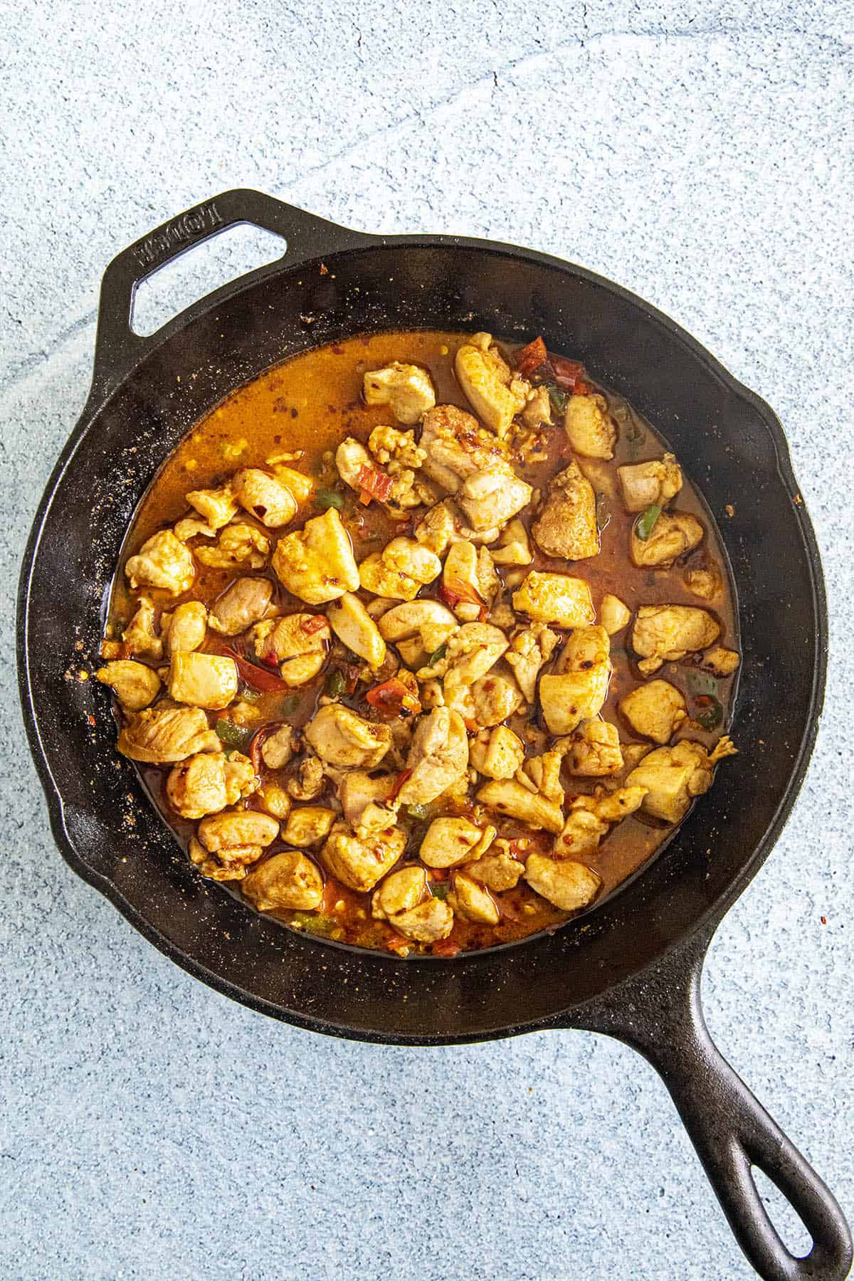 Cooking the chicken and peppers in a pan