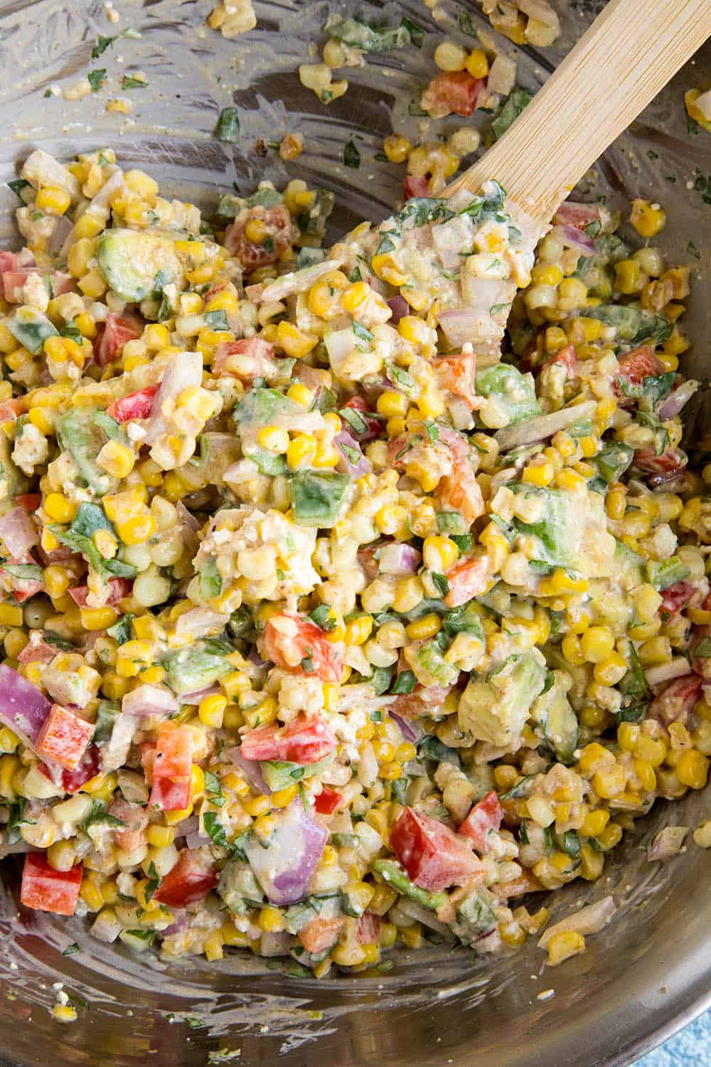 Mixing esquites ingredients in a bowl