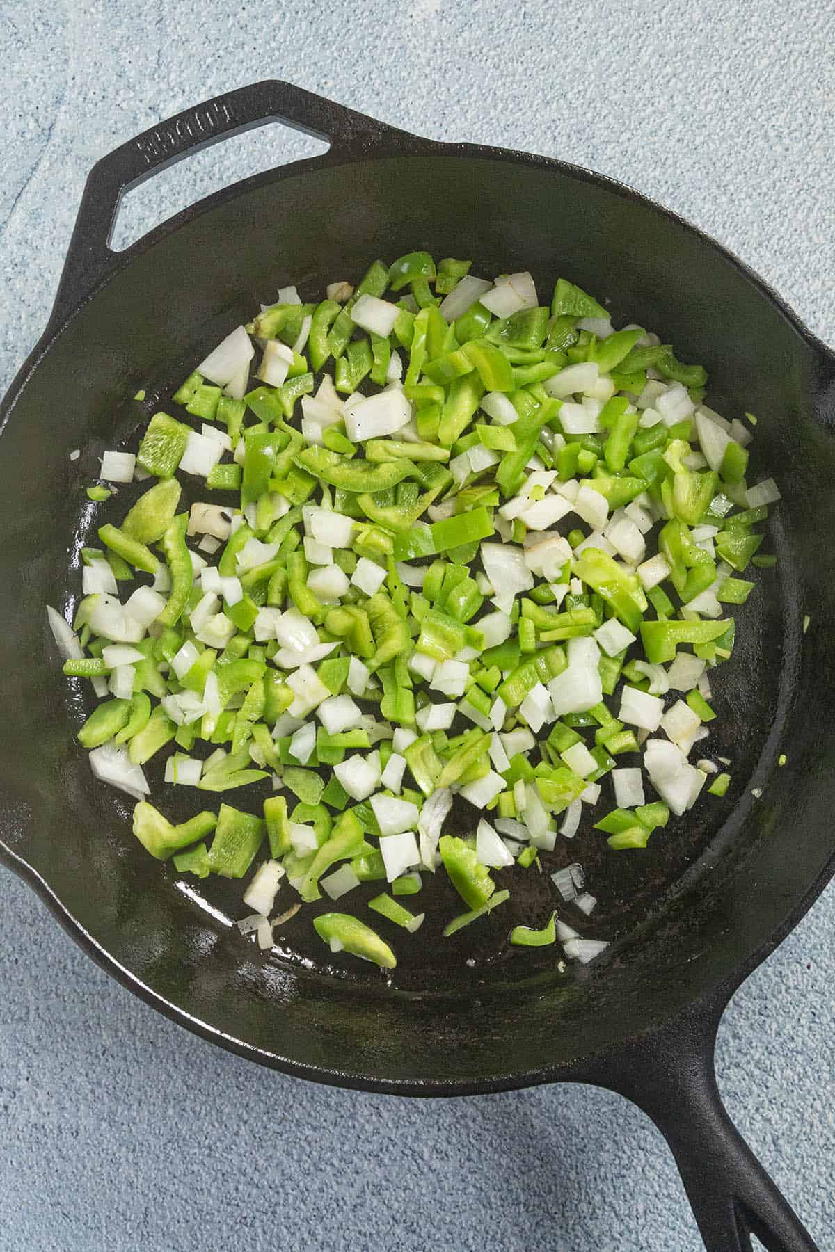 Cooking down onions, peppers, and garlic to make Ratatouille
