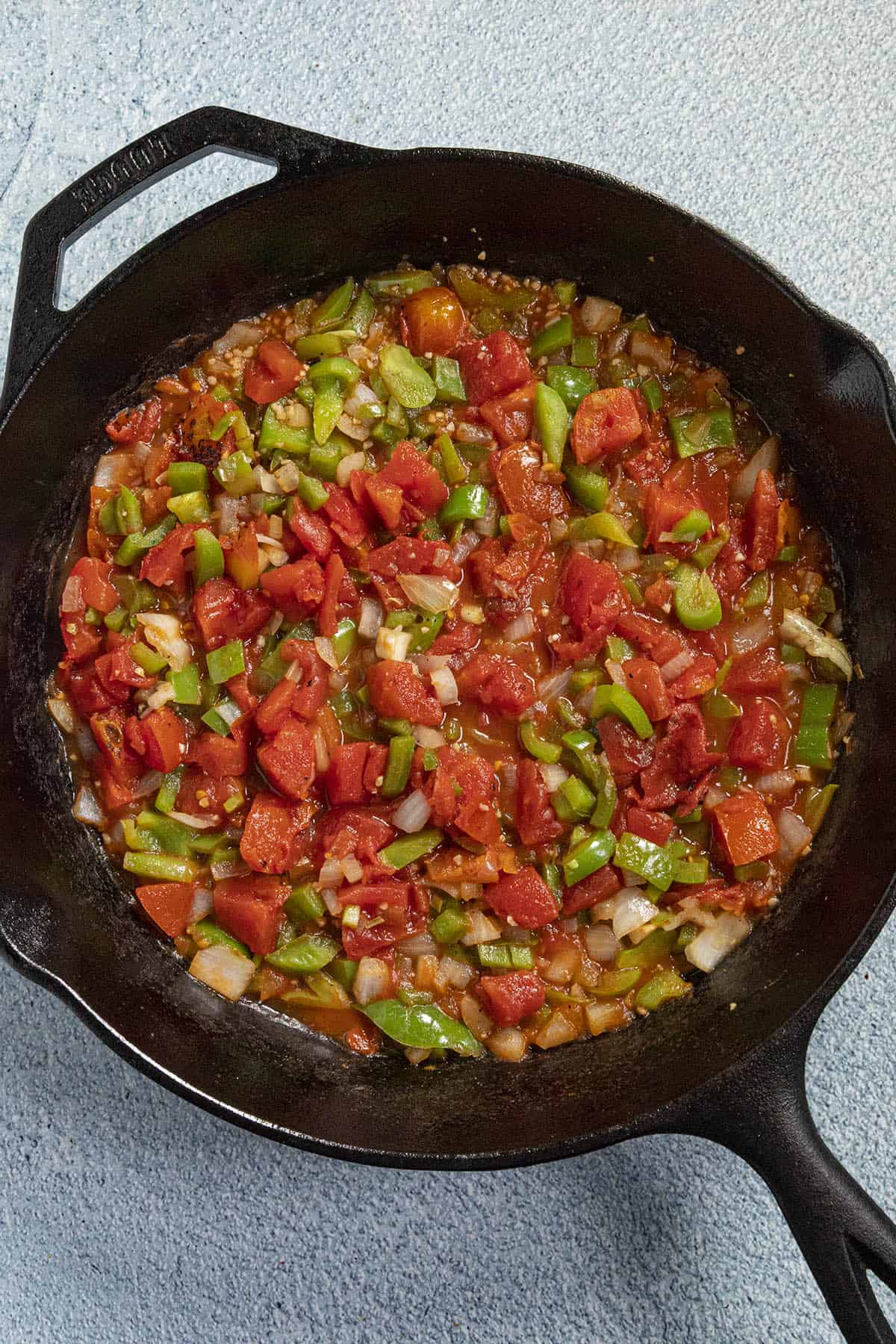 Simmering tomato sauce in a pan to make Ratatouille