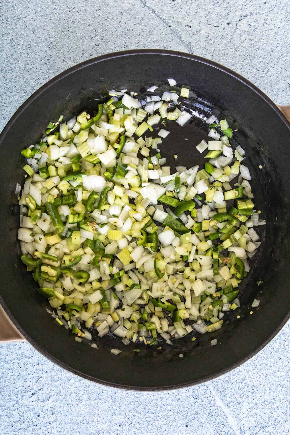 Cooking vegetables in a pot to make Red Beans and Rice