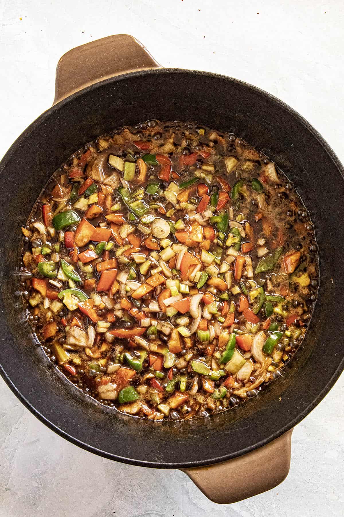 Cooking the vegetables in a roux to make Couvillion