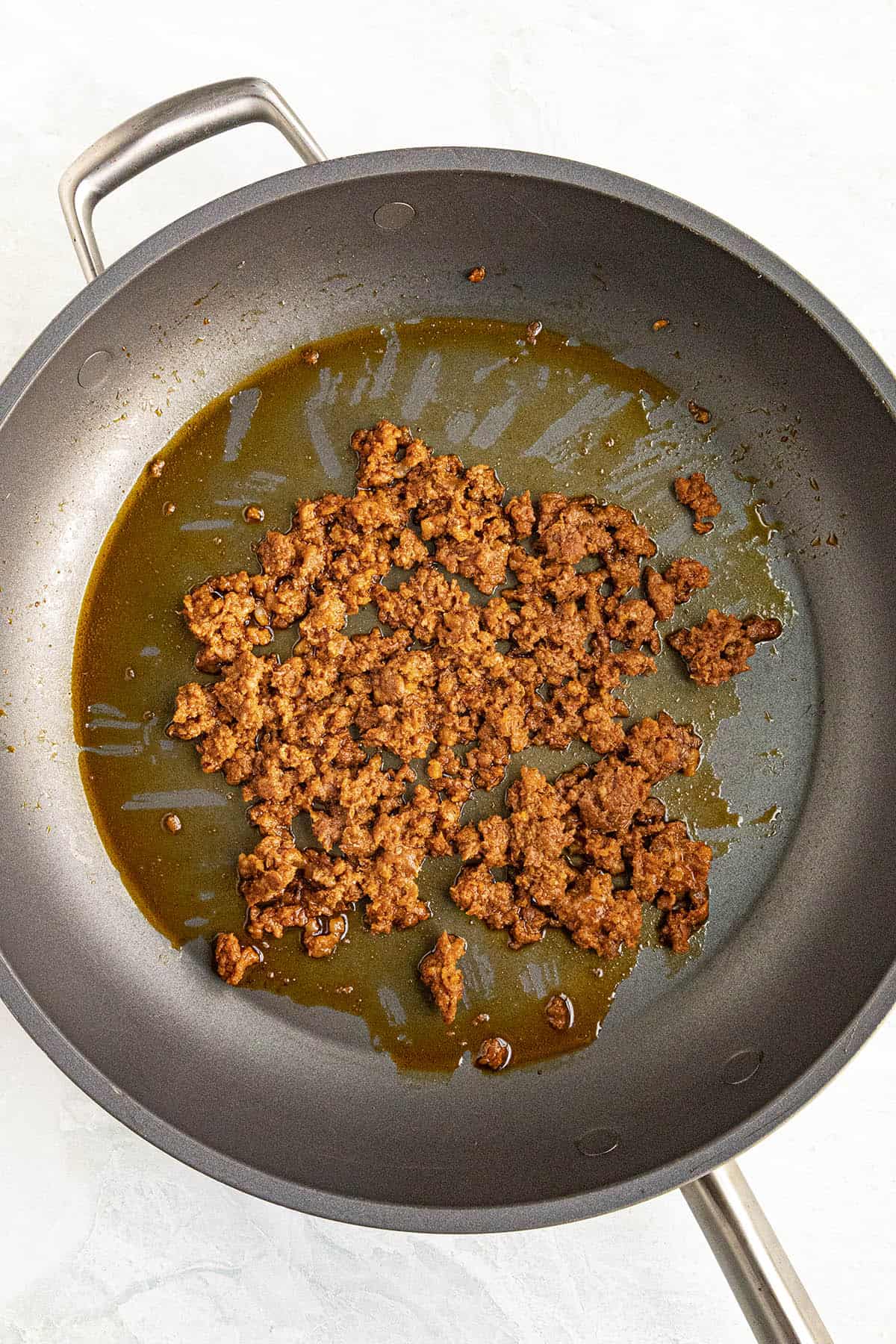 Cooking Mexican chorizo in a pan to make Sopa de Fideo