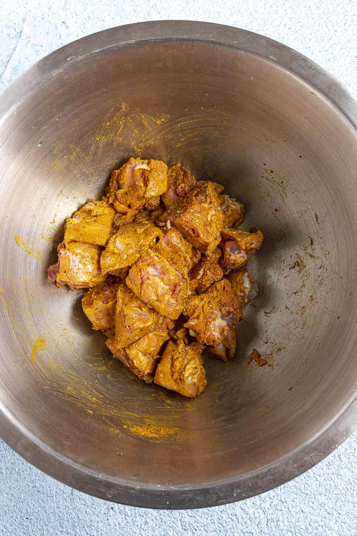 Seasoning the chicken to make Jamaican Curry Chicken