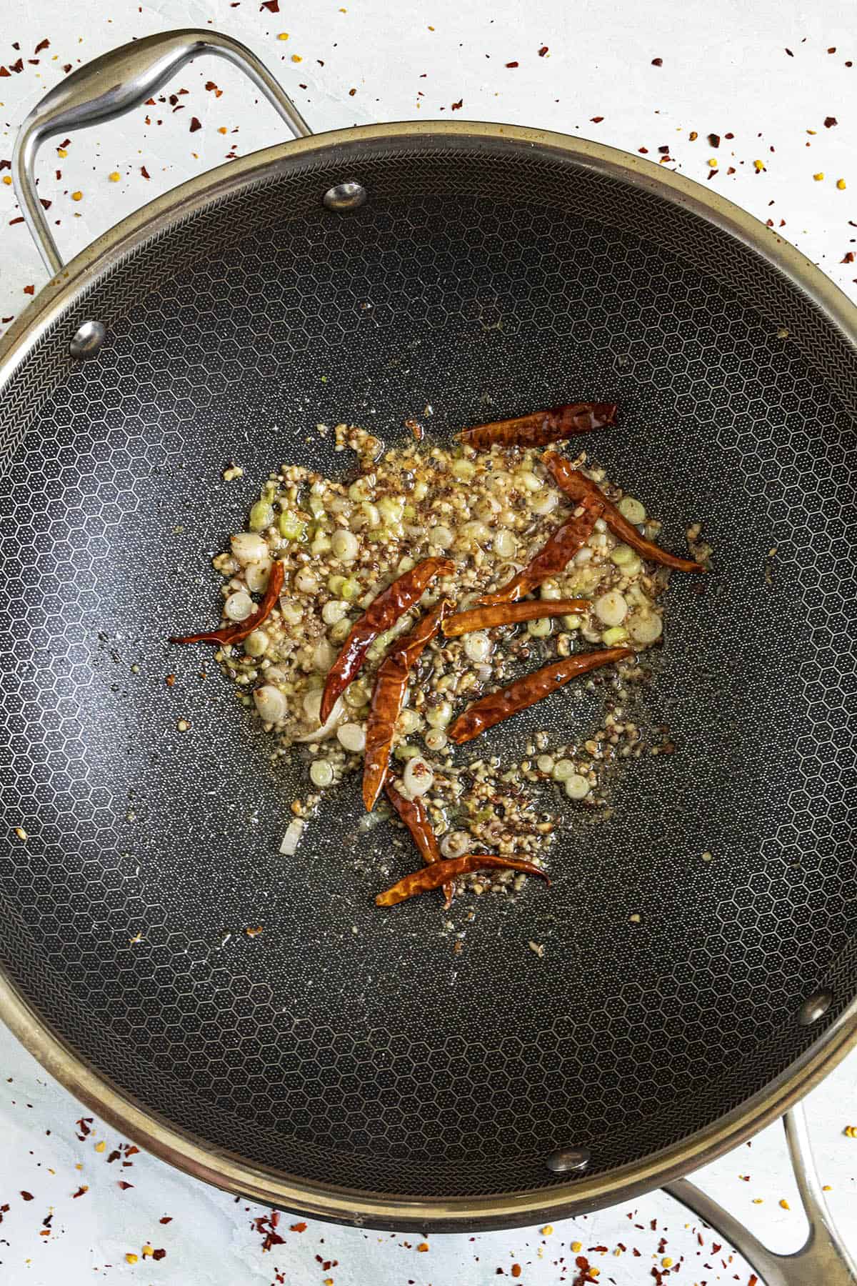 Cooking the vegetables with the chilies to make Kung Pao Sauce