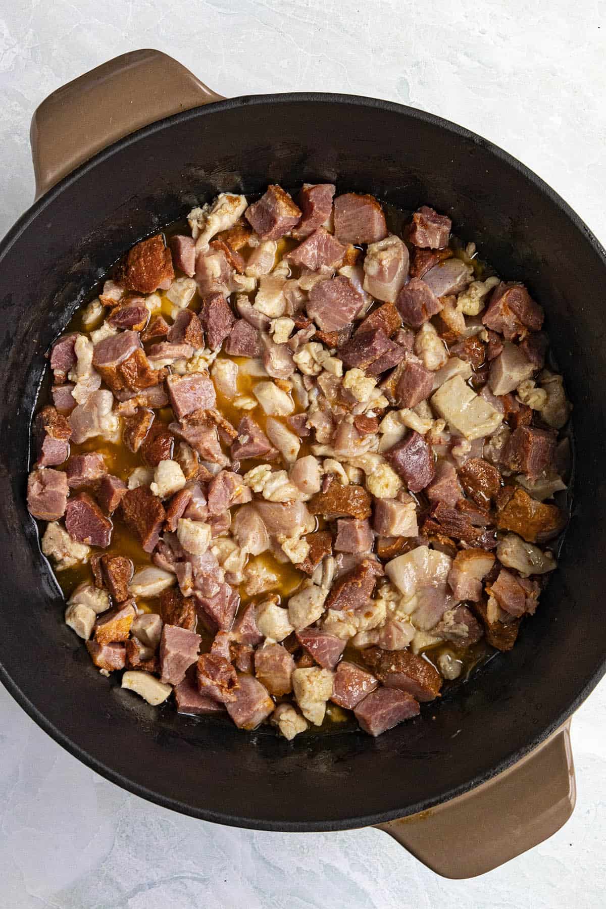 Cooking chicken and tasso ham to make Okra Gumbo