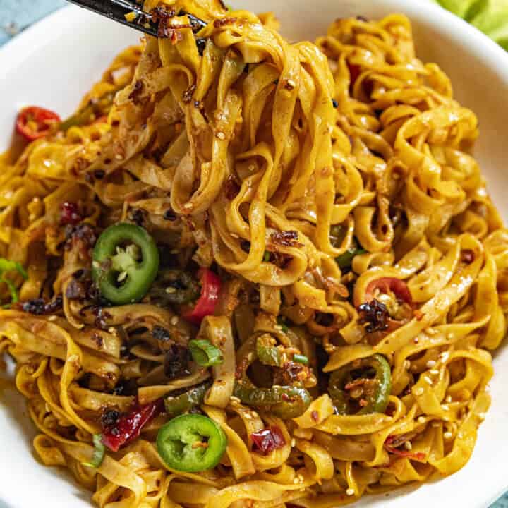 Mike taking a scoop of Spicy Noodles with chopsticks