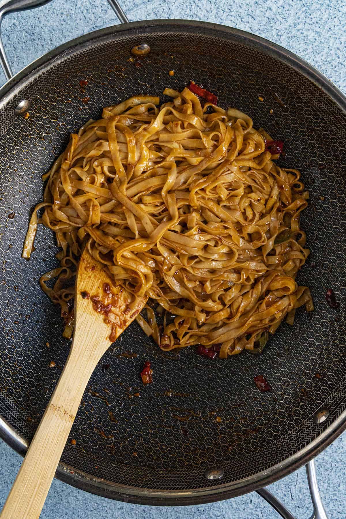 Stir frying the Spicy Noodles in a hot pan