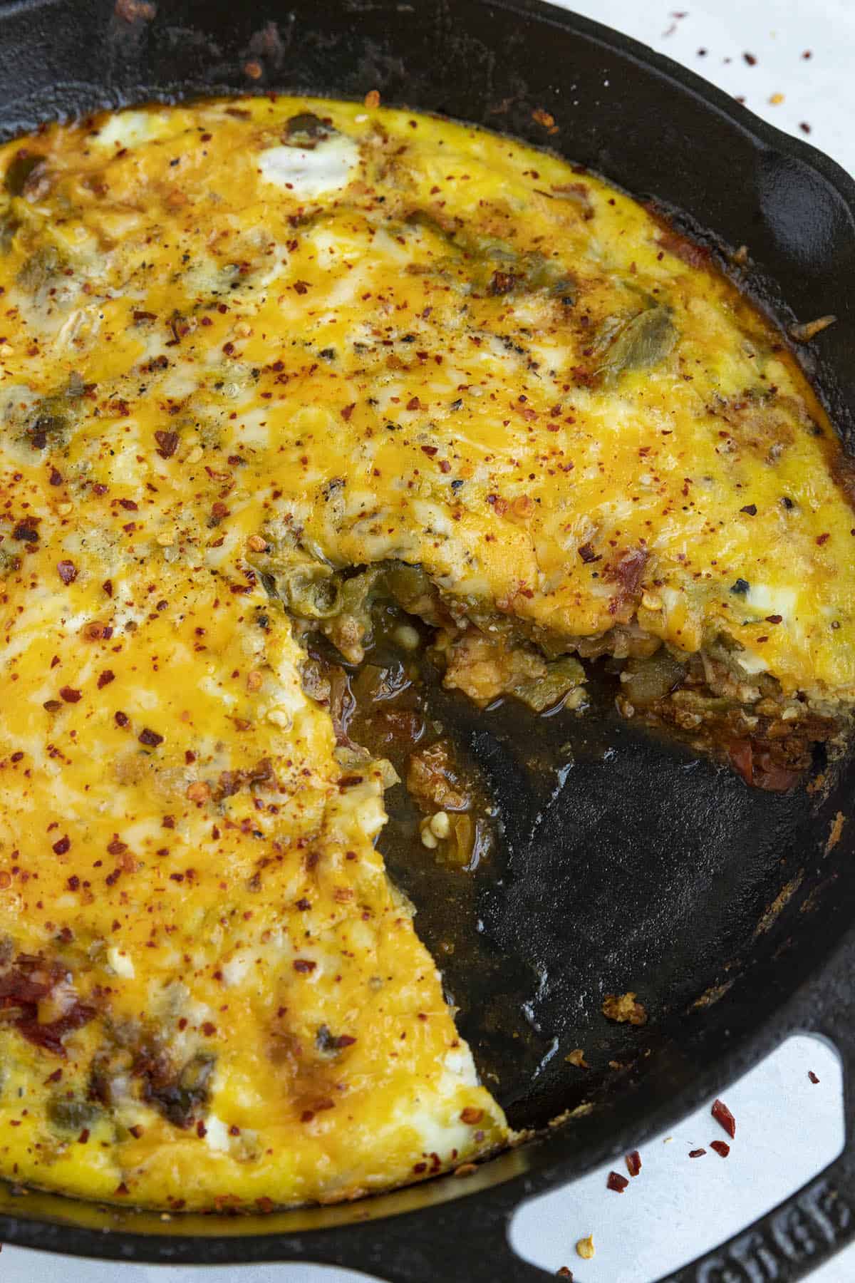 Chile Relleno Casserole in a hot pan with a slice gone