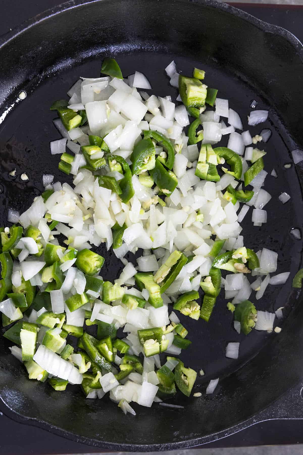 Cooking peppers and onions in a hot pan