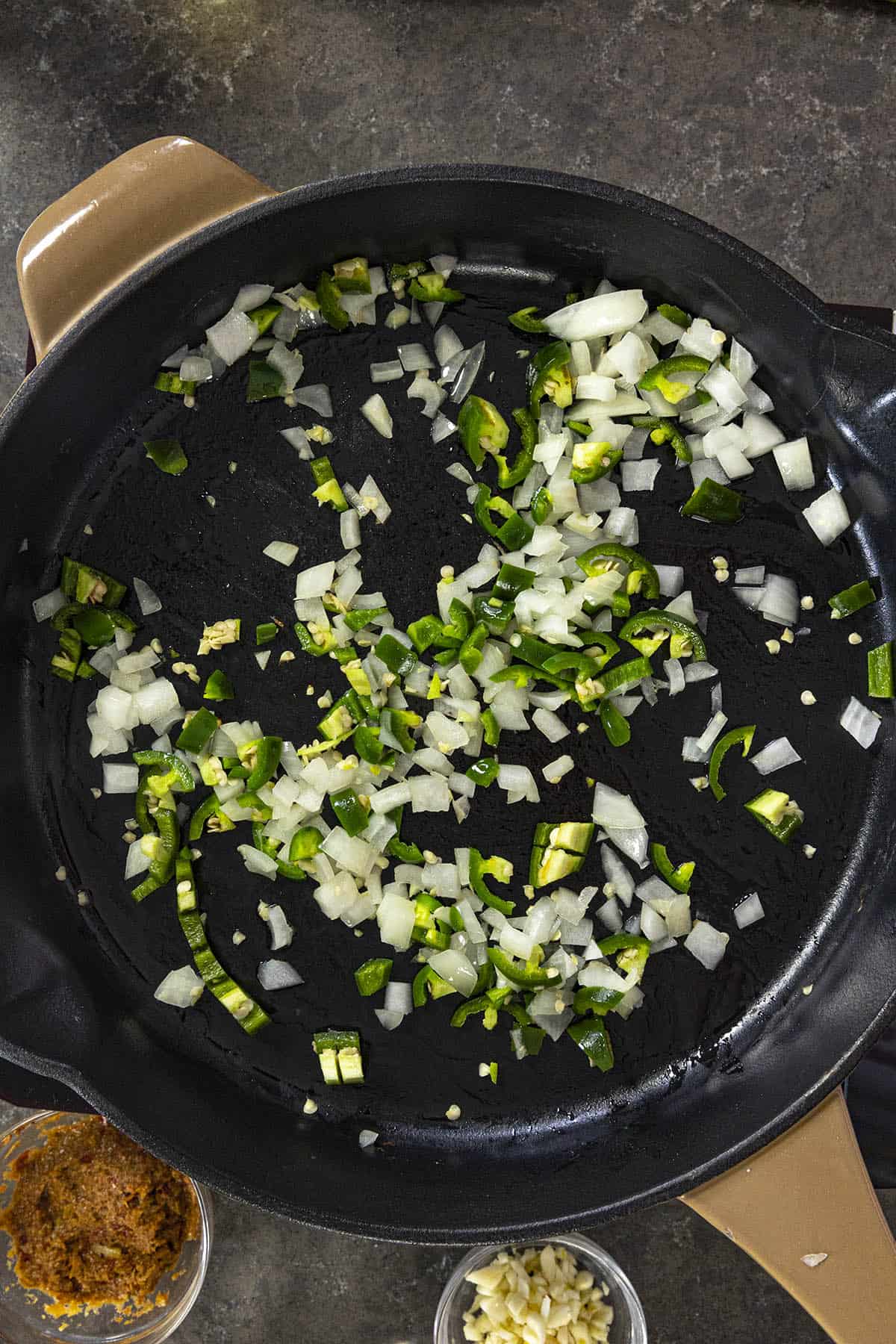 Cooking the peppers and onions to make Coconut Curry Chicken