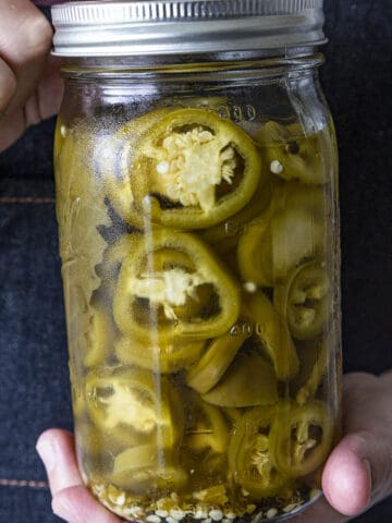 Mike holding Pickled Jalapenos in a jar