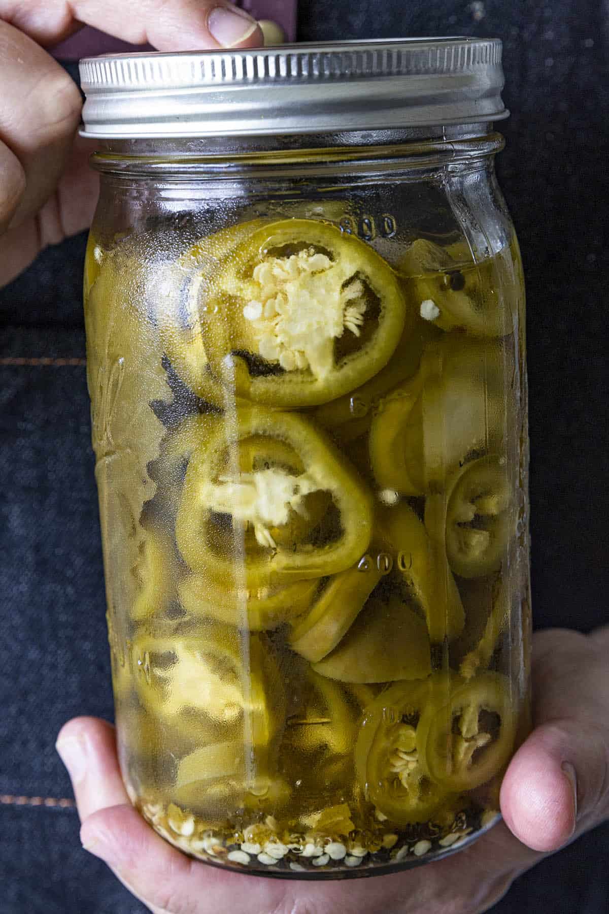 Mike holding Pickled Jalapenos in a jar