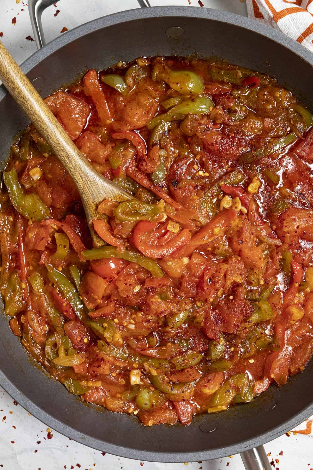 Spicy Piperade in a hot pan with a spoon