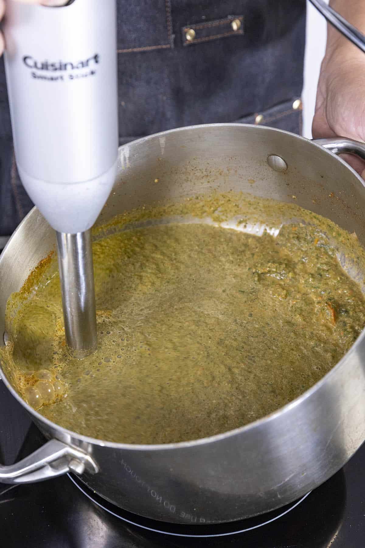 Processing the cooked ingredients in the pot to make Roasted Poblano Soup