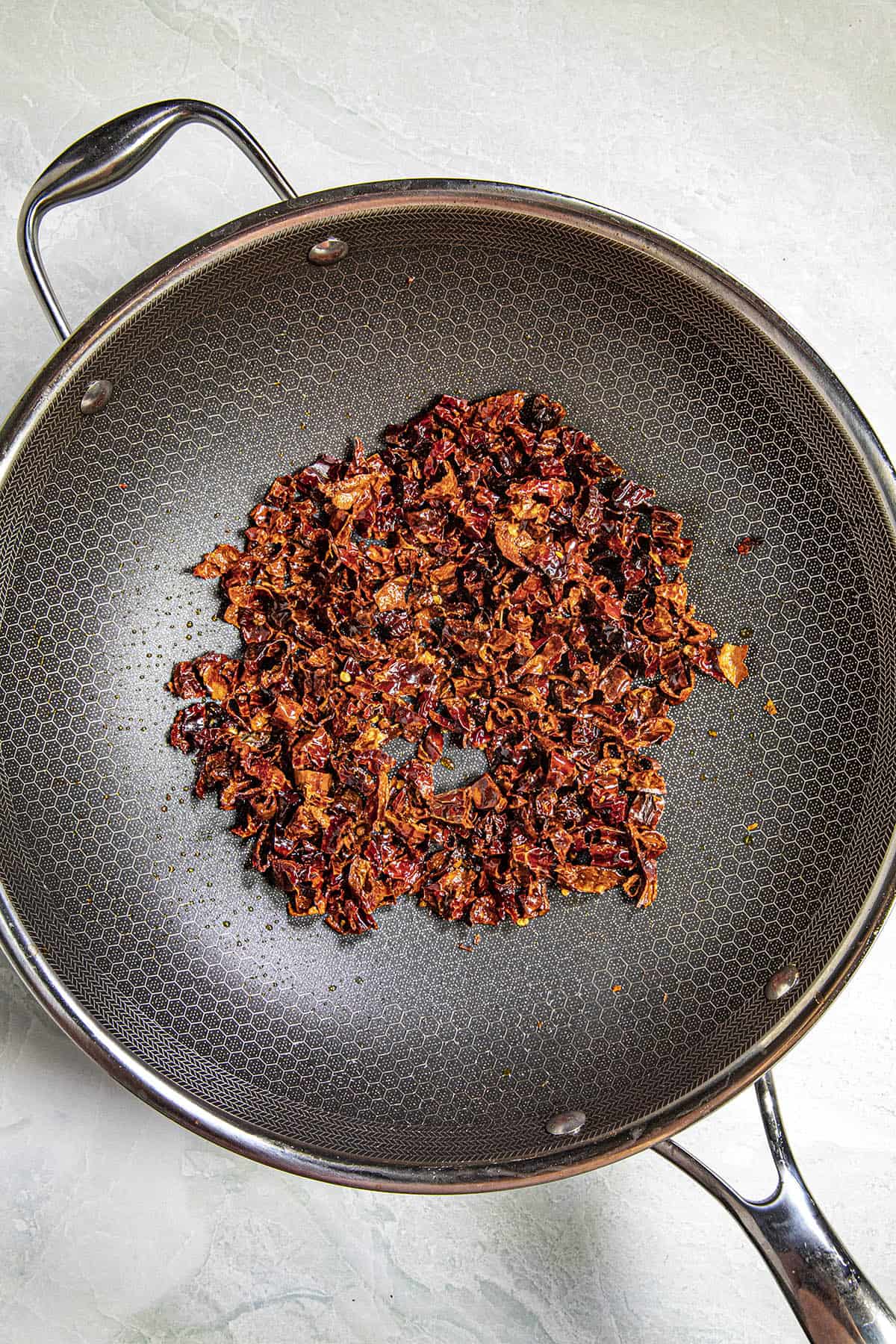 Cooking chilies in a hot pan to make Shuizhu Yu