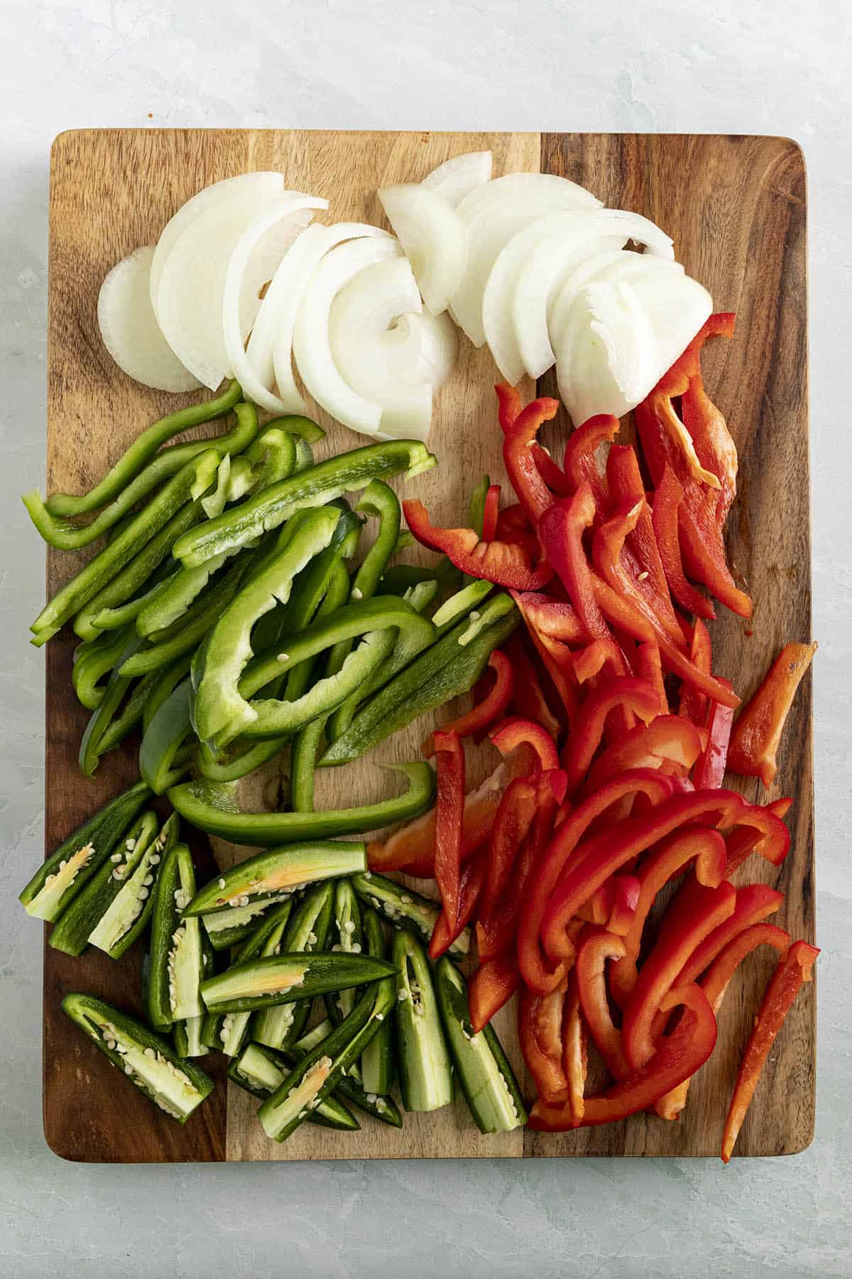 Chopped peppers and onions on a cutting board