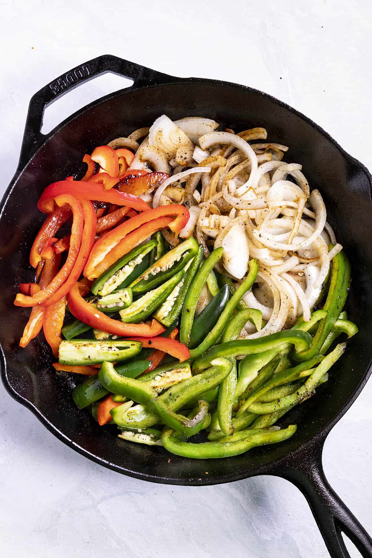 Cooking peppers and onions to make Steak Fajitas