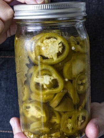 Mike holding Pickled Jalapenos in a jar