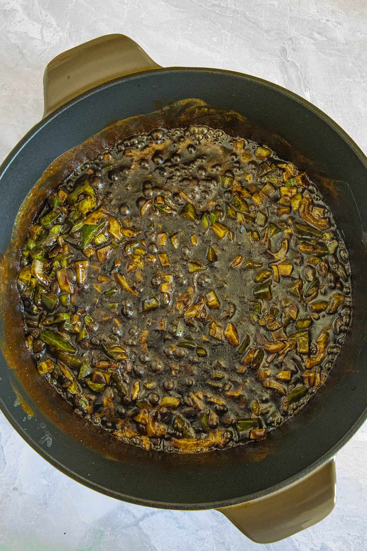 Simmering the holy trinity in the dark roux to make Gumbo Zherbes