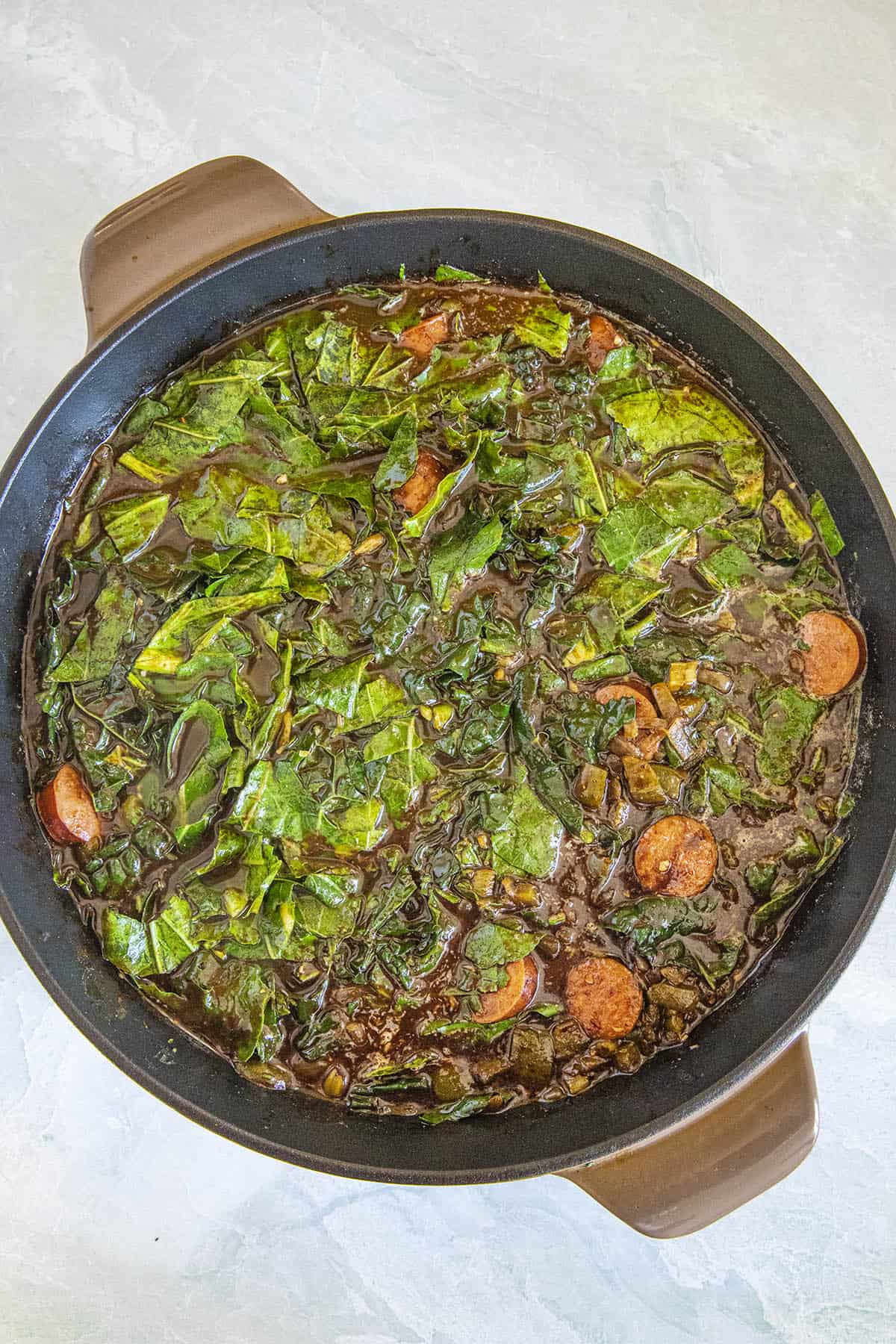 Adding the chopped greens to make Gumbo Zherbes