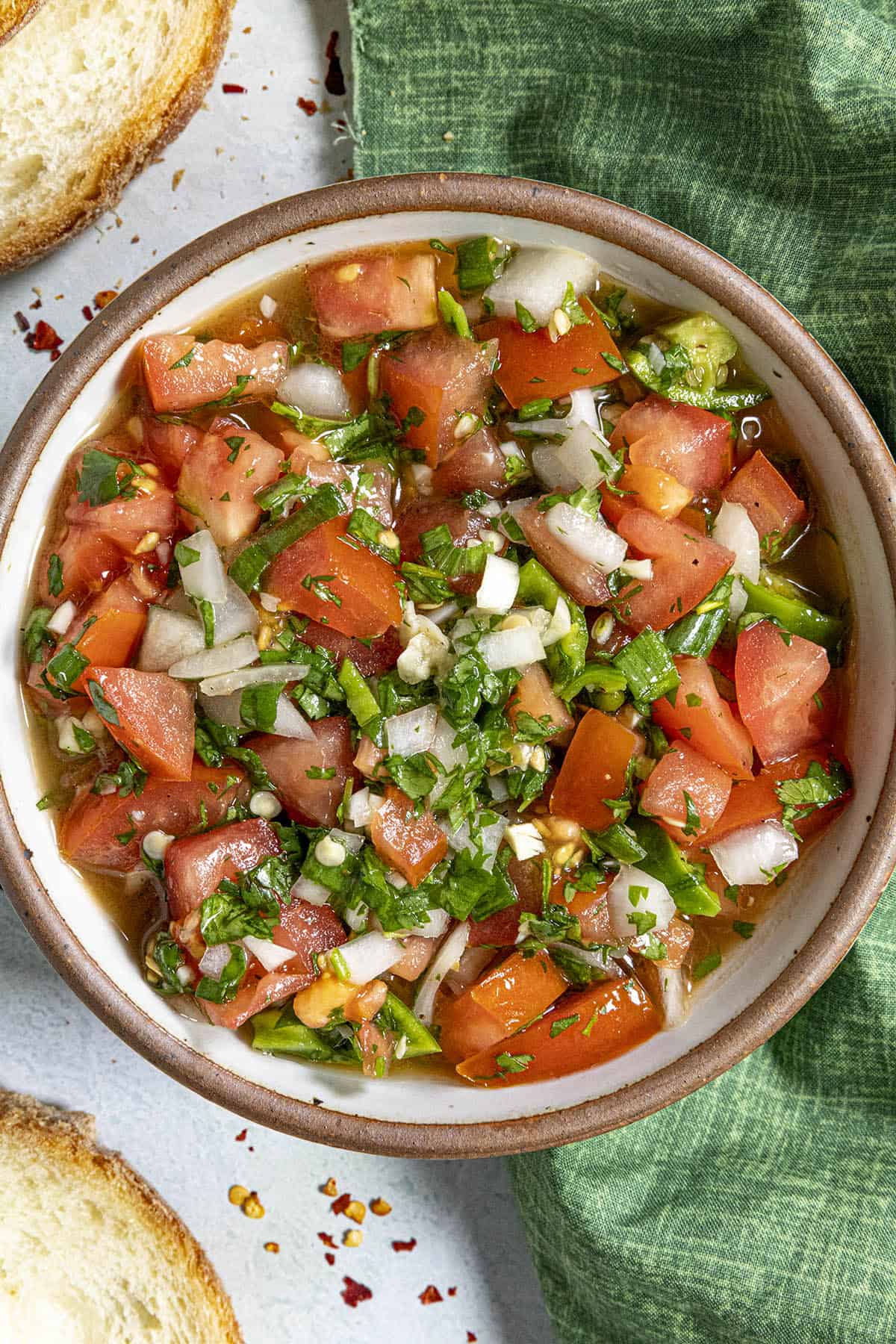 Chunky Pebre in a bowl with garnish