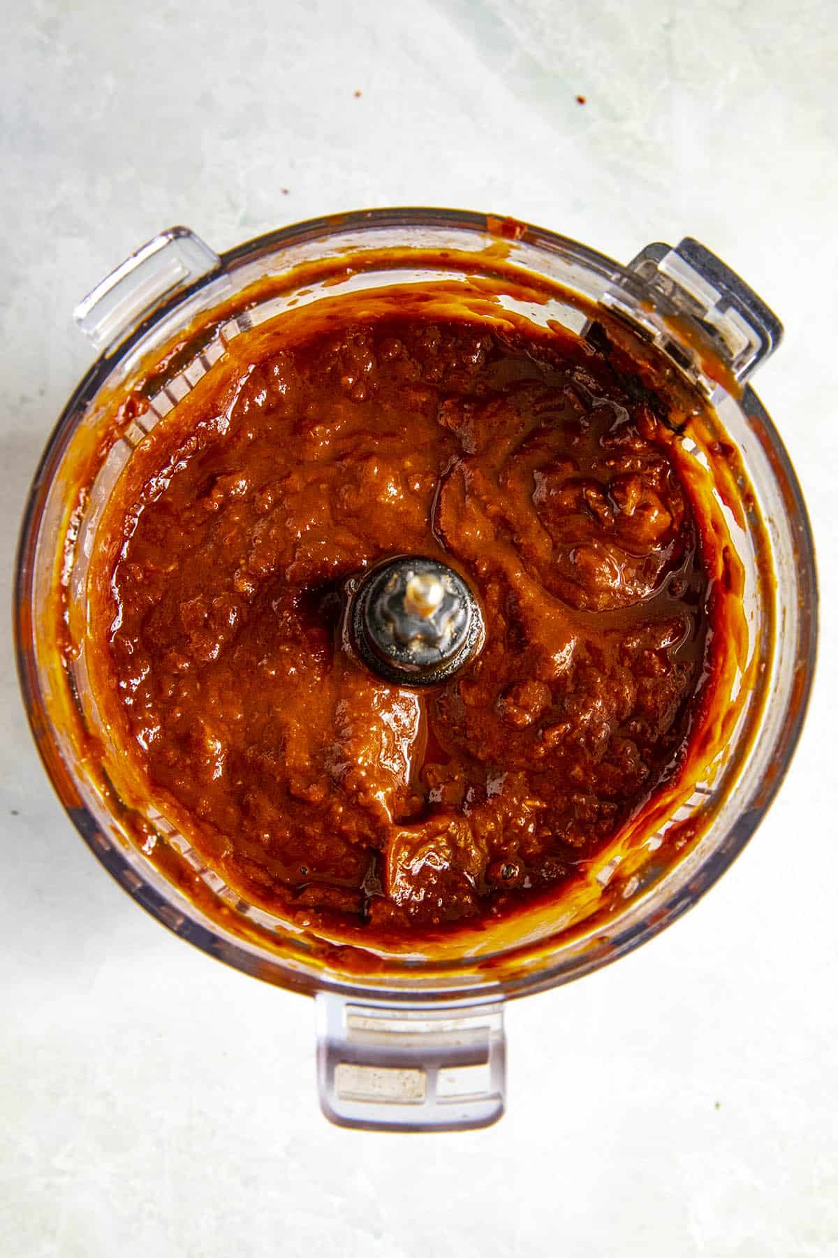 Processed red chili sauce in a food processor for Pozole Rojo