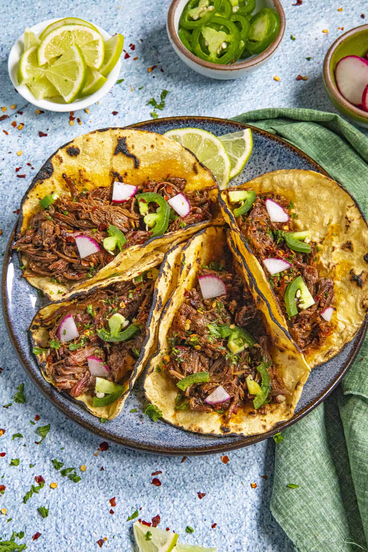 Barbacoa Tacos on toasted corn tortillas with garnish