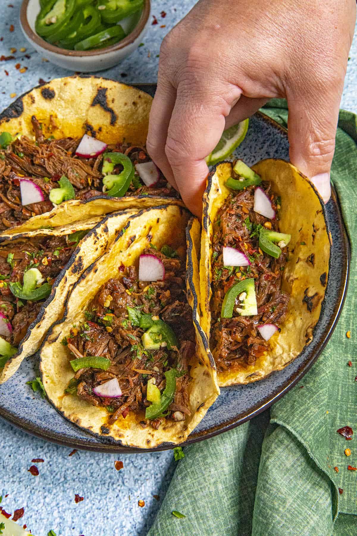 Mike grabbing one of the plated Barbacoa Tacos