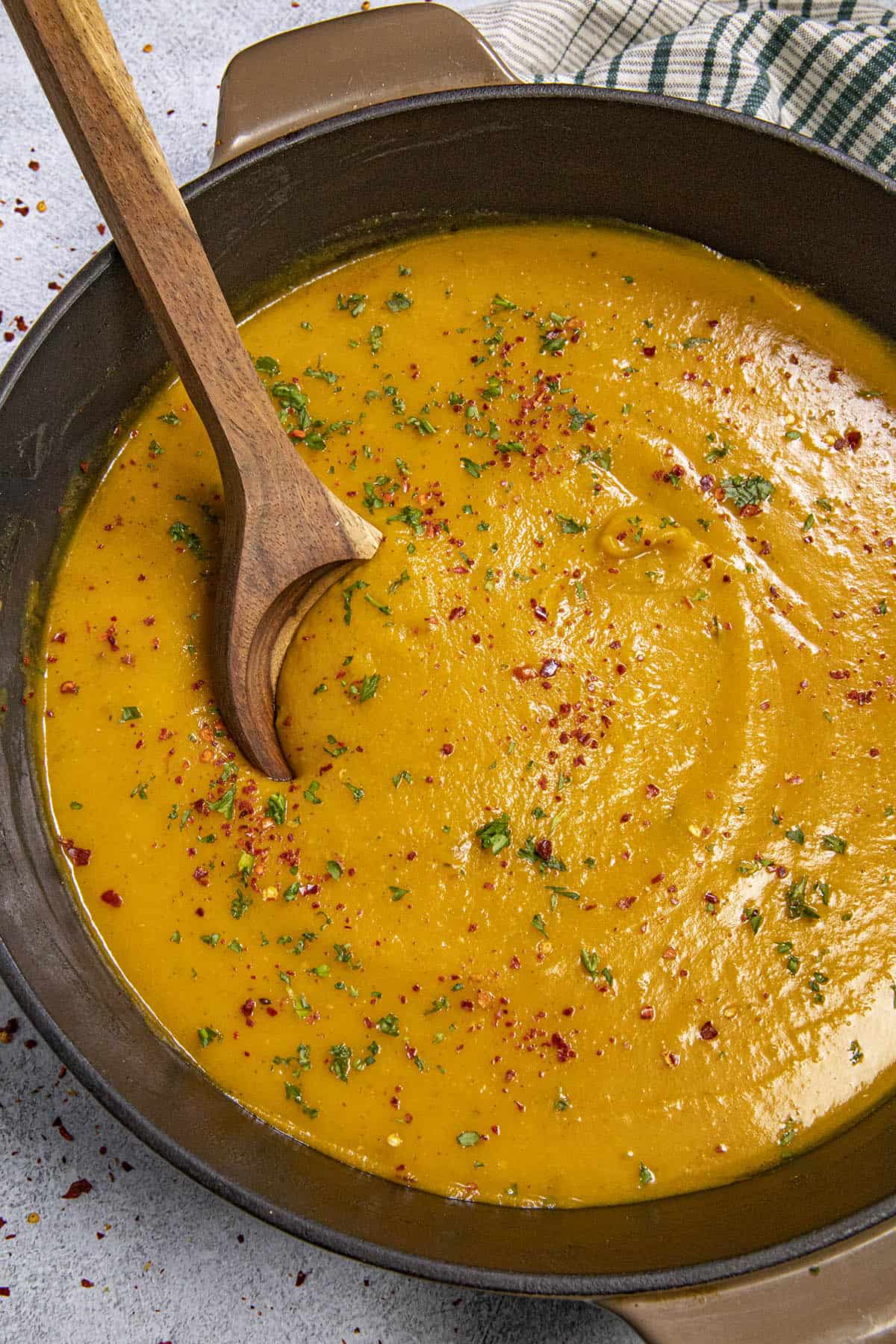 Digging into a pot of Butternut Squash Soup with serving spoon