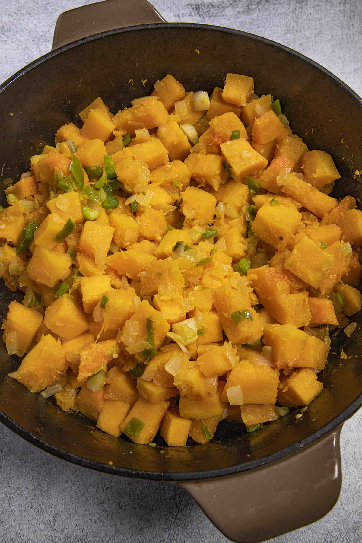 Cooking down butternut squash and vegetables in a pot to make Butternut Squash Soup