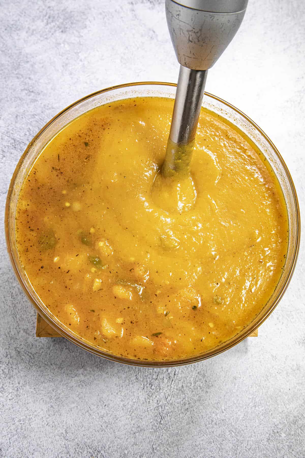 Processing the cooked Butternut Squash Soup ingredients in a bowl until nice and smooth