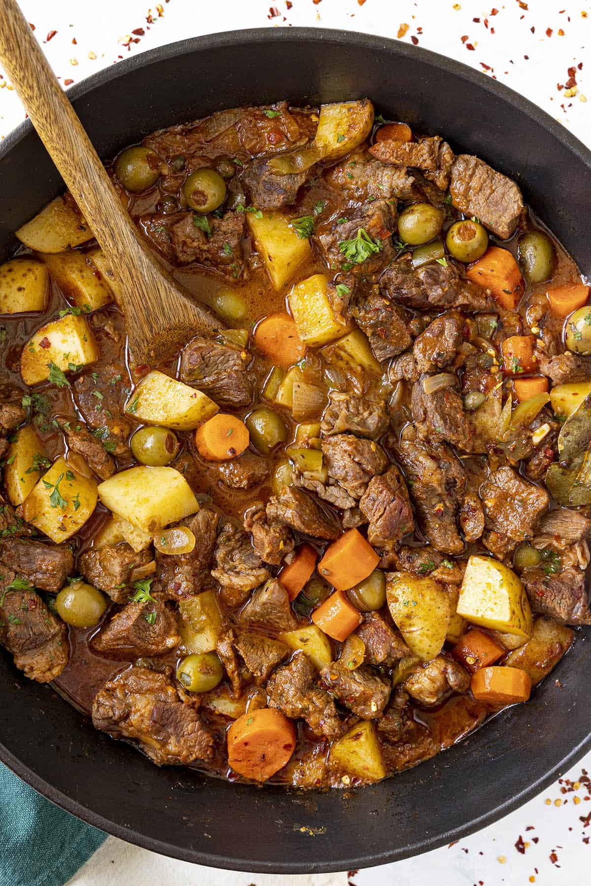 Hearty Carne Guisada in a pot with garnish