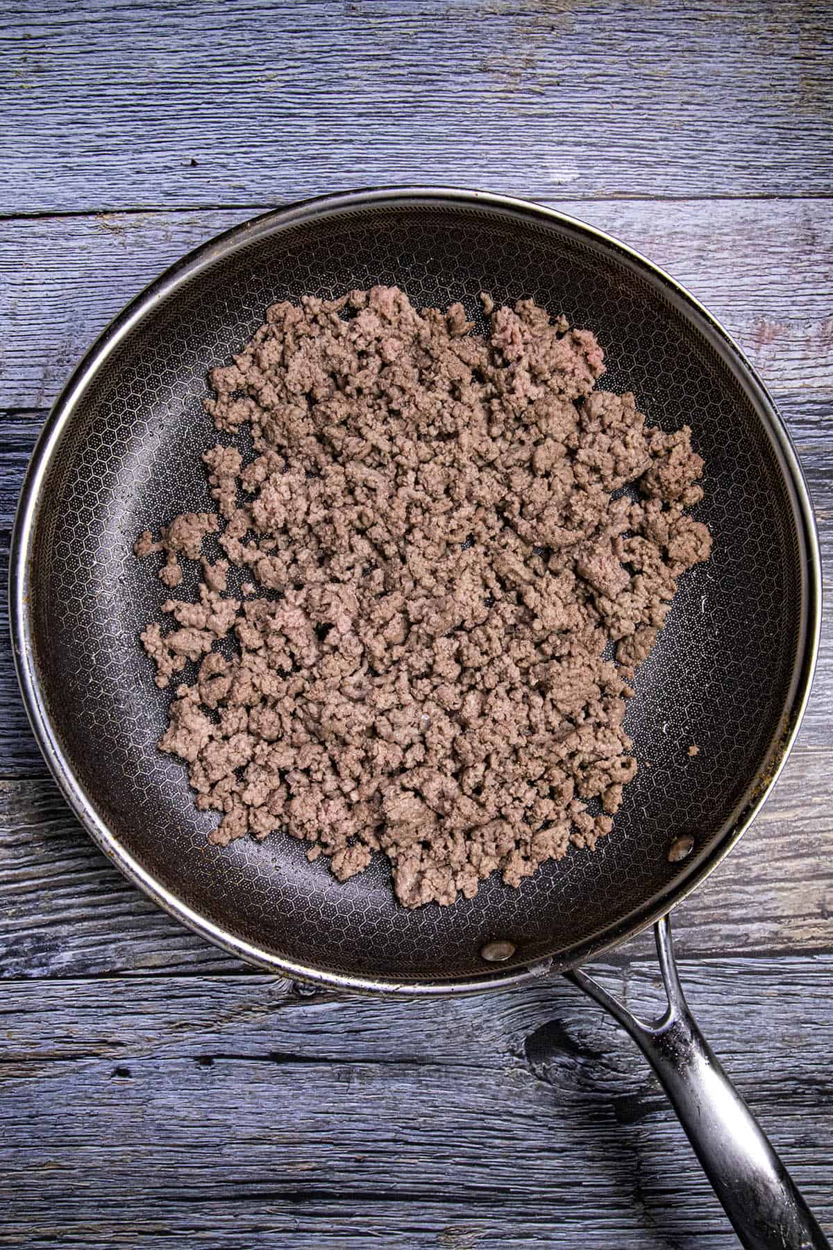 Cooking ground beef in a pan for nachos