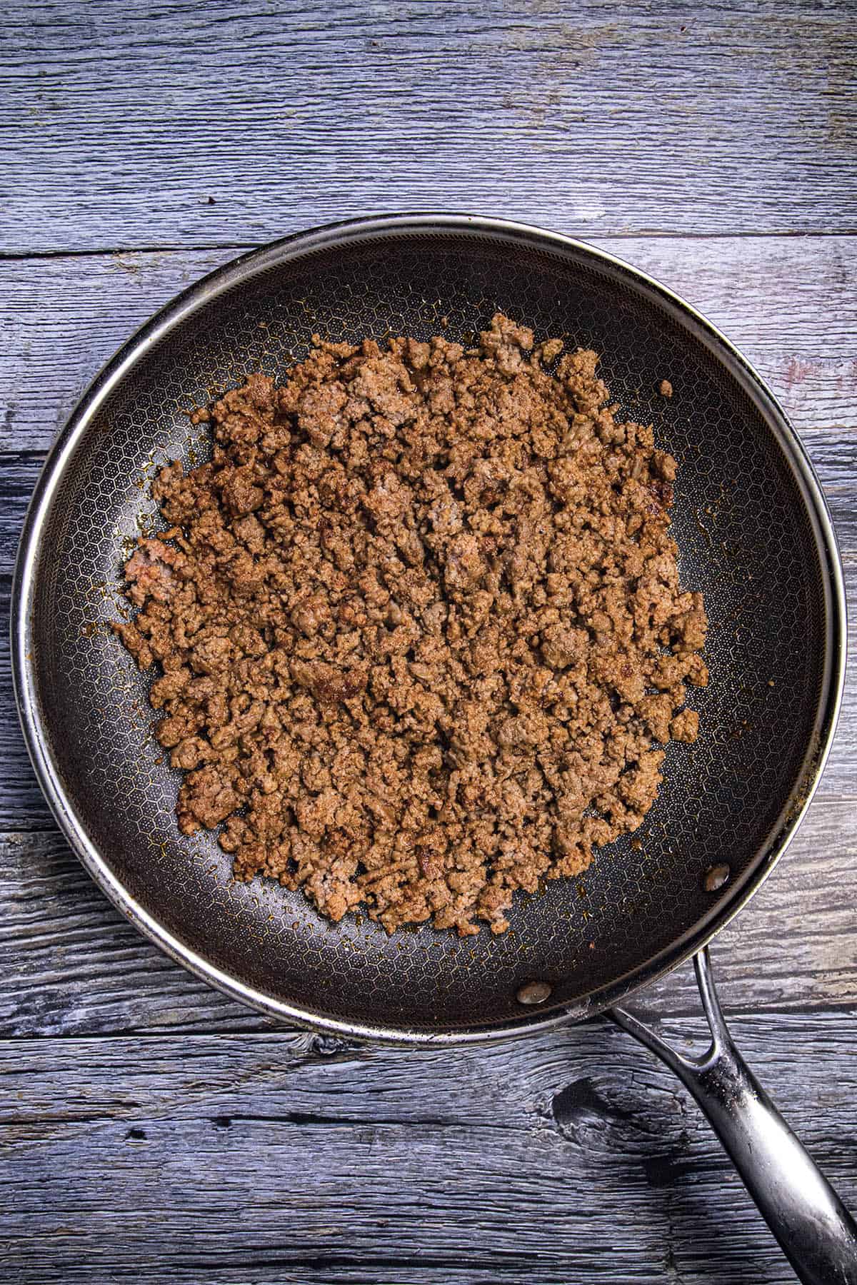 Simmering the taco meat in a pan for nachos
