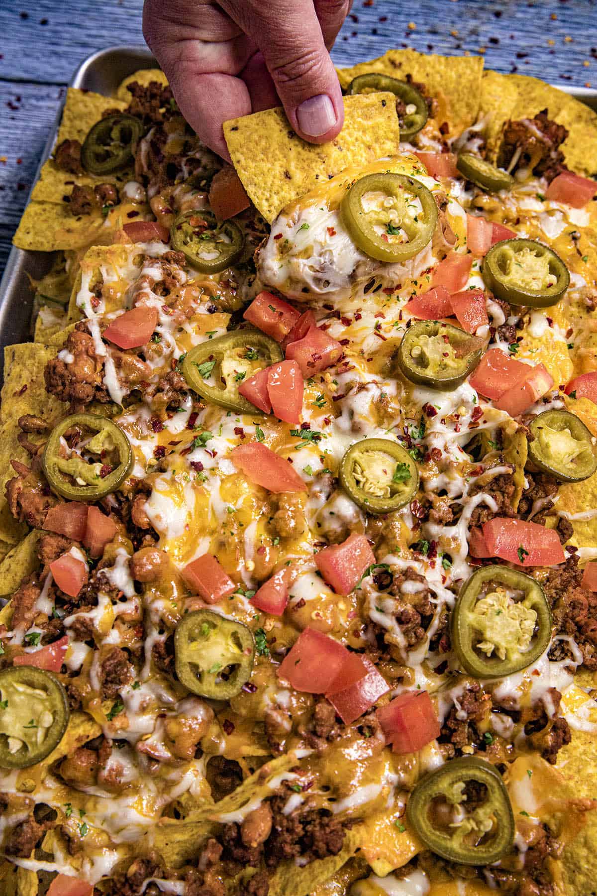 Mike taking a nacho from the pan