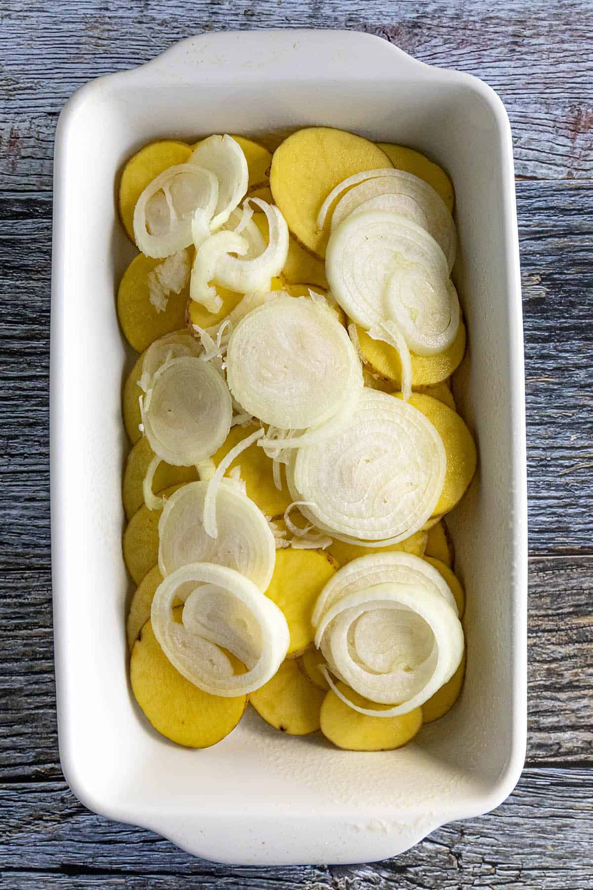 Layering Scalloped Potatoes and Onions into a baking dish
