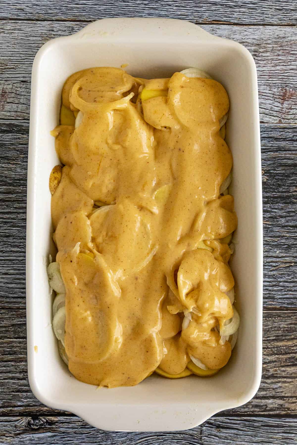 Scalloped Potatoes topped with cheese sauce